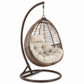 Sedia a dondolo sospesa in rattan con cuscino in cotone beige