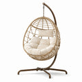 Sedia a dondolo in rattan con cuscino beige